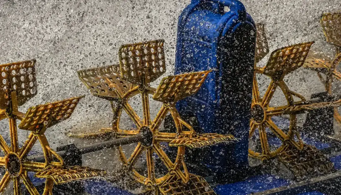 A paddlewheel aerator at work, the kind of equipment that keeps the oxygen up