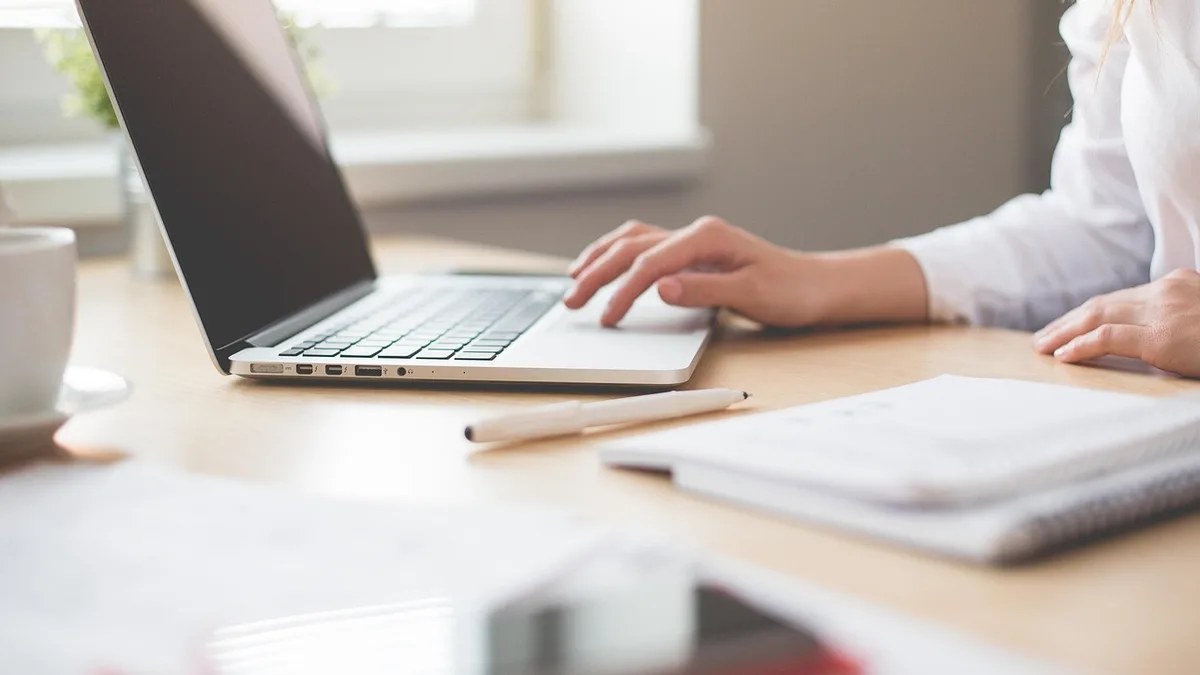 A founder working alone at a laptop in a home office