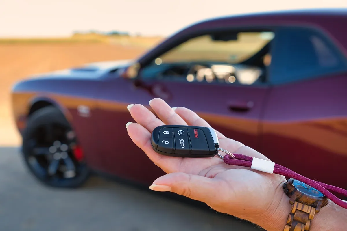 Handing car keys back to a customer
